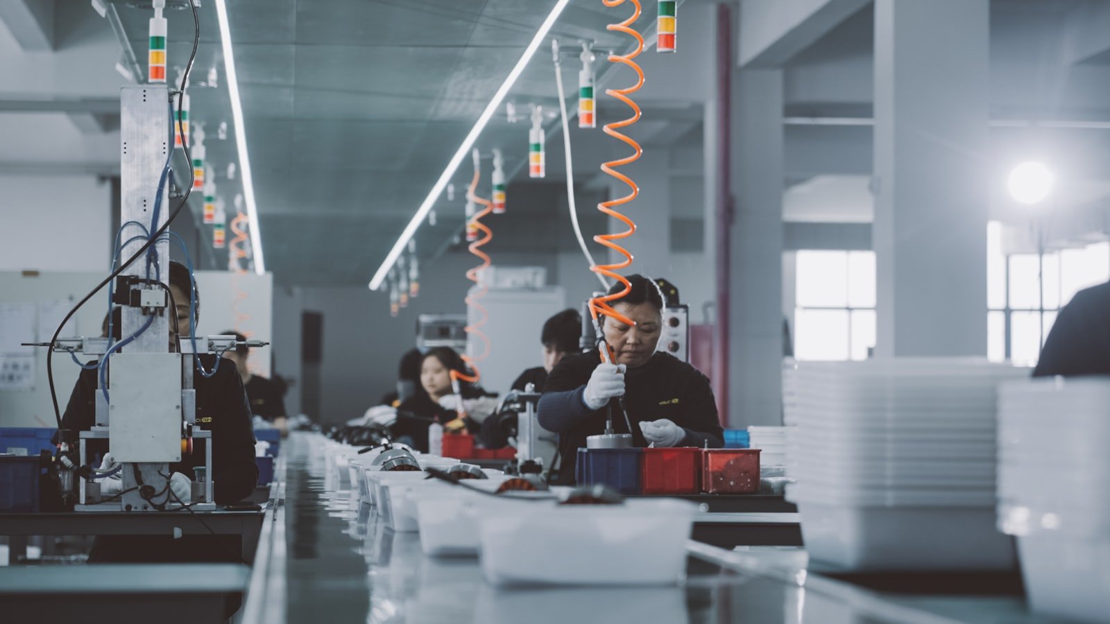 Operators inspecting components on an assembly line